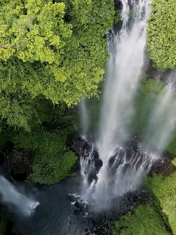 Drone shot of a waterfall in the rainforest – symbolising Lightnet's commitment to sustainability.