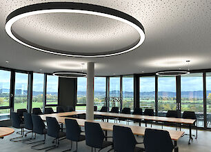 The magistrate's room in the new town hall of Viernheim radiates modern elegance. The iconic circular shape of the Ringo Star pendant luminaires from Lightnet ensures uniform and glare-free illumination of the conference room. The generous window areas allow plenty of daylight in, while the matt black luminaires harmoniously complement the minimalist interior design. This combination of energy-efficient LED technology and timeless design creates an optimal atmosphere for meetings and decision-making processes in a public building.