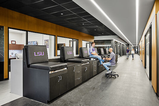 Modern rehabilitation area with treatment tables, LSU branding and integrated LED strip lighting