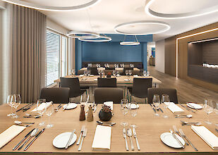 Elegant meeting and dining area with set tables and large round pendant lights from Lightnet