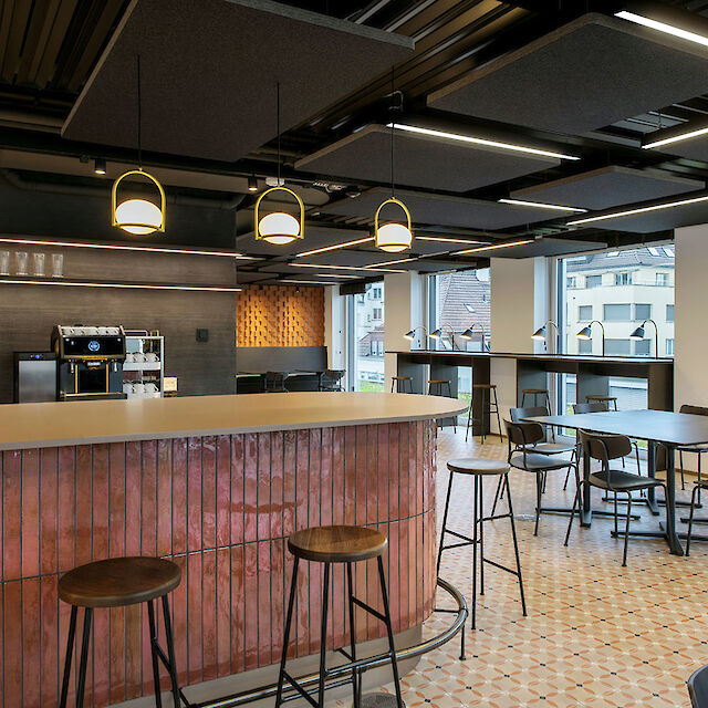 Modern lounge area with bar and Matric light lines that design the room with a clear, uniform light structure