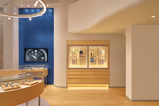 Boutique interior with round display case, Ringo Star pendant light, Midpoint spotlights and warm lighting