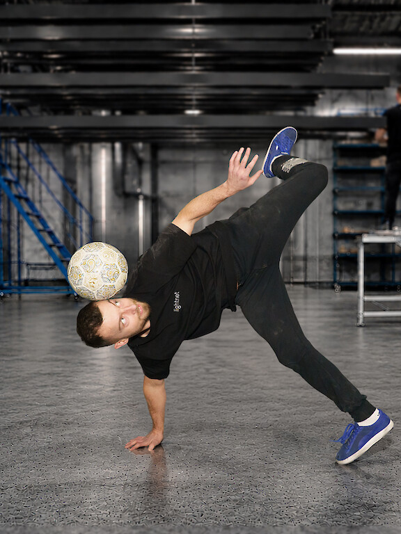 Lightnet employee performing freestyle soccer in the production area.