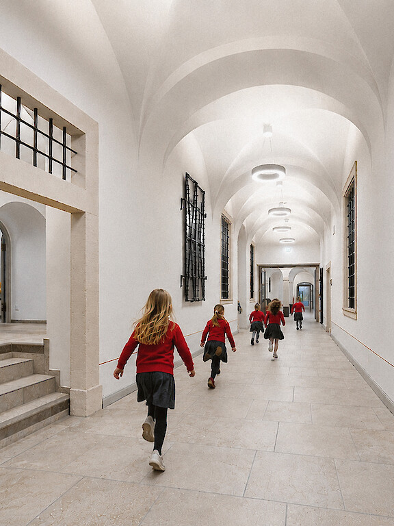 Students in a historic school corridor with Ringo Star pendant luminaires.