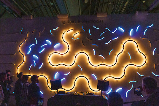 Glowing organic lines in blue and yellow displayed in front of visitors.