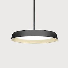 A modern, round and flat pendant luminaire with a black rim and golden reflector ring, suspended from a thin black cable. The background is grey.