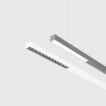 The picture shows a section of two linear pendant luminaires, one with a white and one with a grey surface and blind areas in the middle. The underside of the white luminaire is also fitted with a silver-coloured lenticular louvre, with each lens containing a small LED light. The grey luminaire also has a smooth cover. Both lights have a modern design and are suspended from the ceiling on thin cables. The background is grey.