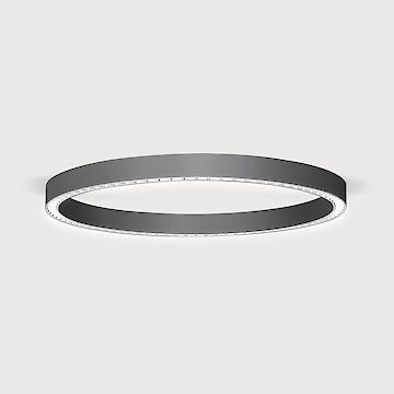 The picture shows a modern, ring-shaped surface-mounted luminaire that emits a diffuse, soft light downwards. The surface of the luminaire has a matt black texture. The background of the picture is a uniform light grey.