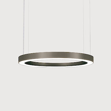 A modern, ring-shaped pendant luminaire with a slender, grey frame. The luminaire is suspended from thin wires and emits a diffuse, soft light downwards. The background is plain grey and draws the eye to the elegant luminaire.