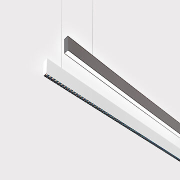 The picture shows a section of two linear pendant luminaires, one with a white and one with a grey surface. The bottom of the white luminaire is fitted with a black lenticular louvre, with each lens containing a small LED light. The black luminaire has a smooth cover. Both luminaires have a modern design and are suspended from the ceiling on thin cables. The background is grey.