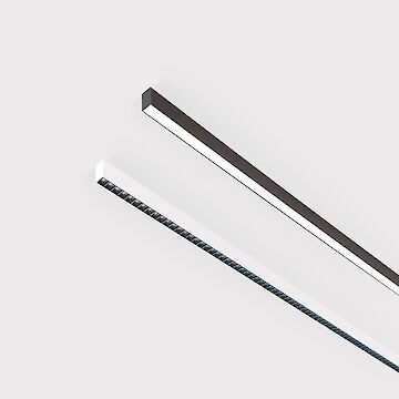 The picture shows a section of two linear surface-mounted luminaires, one with a white and one with a black surface. The underside of the white luminaire is fitted with a black louvre, with each lens containing a small LED light. The black luminaire has a smooth cover. Both lights have a modern design. The background is grey.