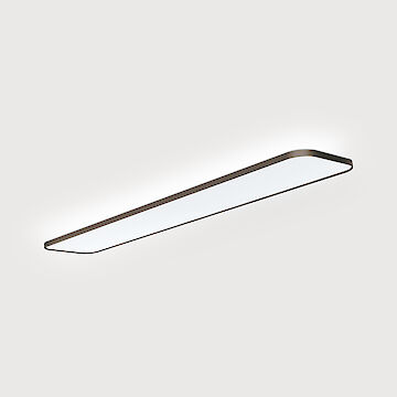 A modern surface-mounted luminaire with a slender, rectangular design. The luminaire has rounded corners and uniform light distribution over the entire surface. The housing has an elegant metal finish and the luminaire emits a bright, uniform light.