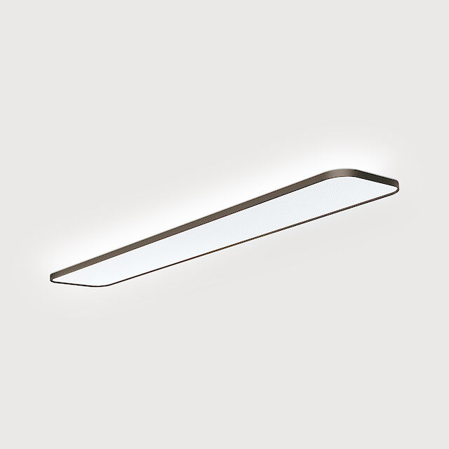 Eine moderne Anbauleuchte mit einem schlanken, rechteckigen Design. Die Leuchte hat abgerundete Ecken und eine gleichmäßige Lichtverteilung über die gesamte Fläche. Das Gehäuse ist in einer eleganten Metalloberfläche gehalten, und die Leuchte strahlt ein helles, gleichmäßiges Licht aus.