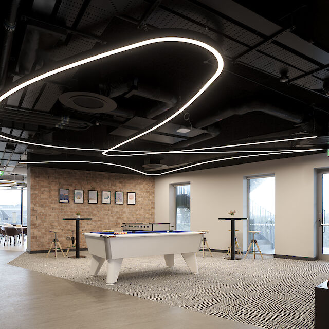 Spacious, modern office with large pendant luminaires that provide soft, uniform light. A minimalist interior design complements the modern design of the room.
