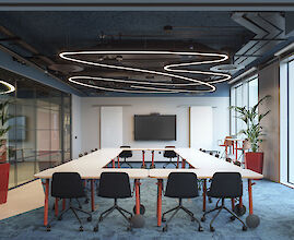 Spacious, modern office with large pendant luminaires that provide soft, uniform light. A minimalist interior design complements the modern design of the room.